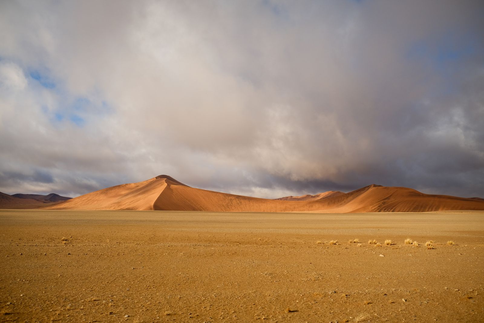 Dramatic sky over desert dunes